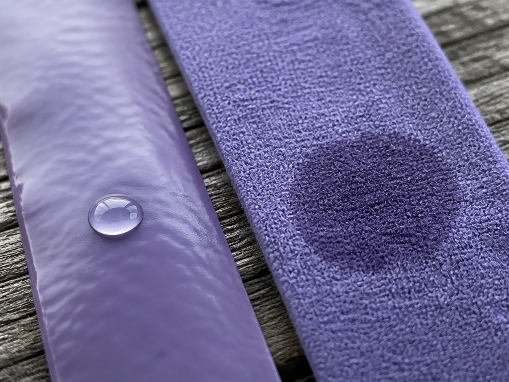 Extreme close-up, almost macro, of two overgrip materials side by side on a weathered…
